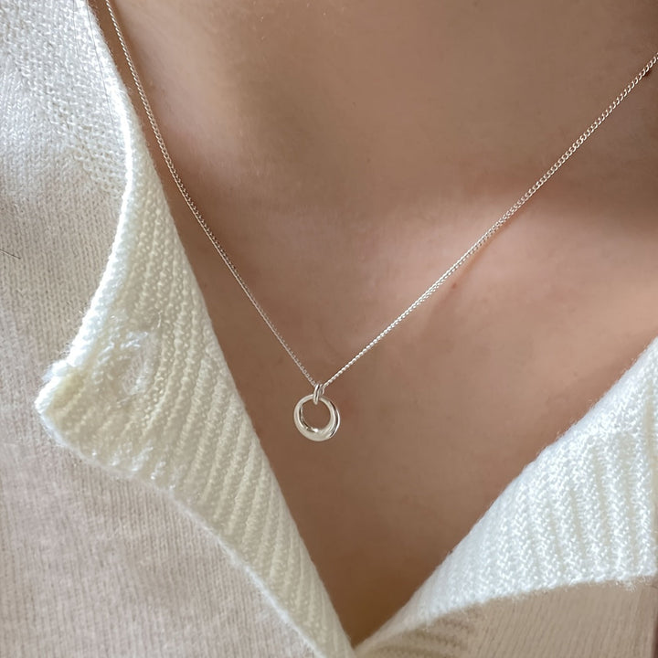White gold necklace with circular geometric pendant