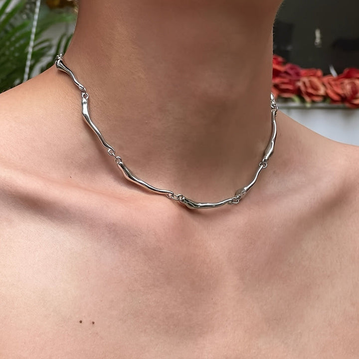 White gold necklace with an intertwined wave design