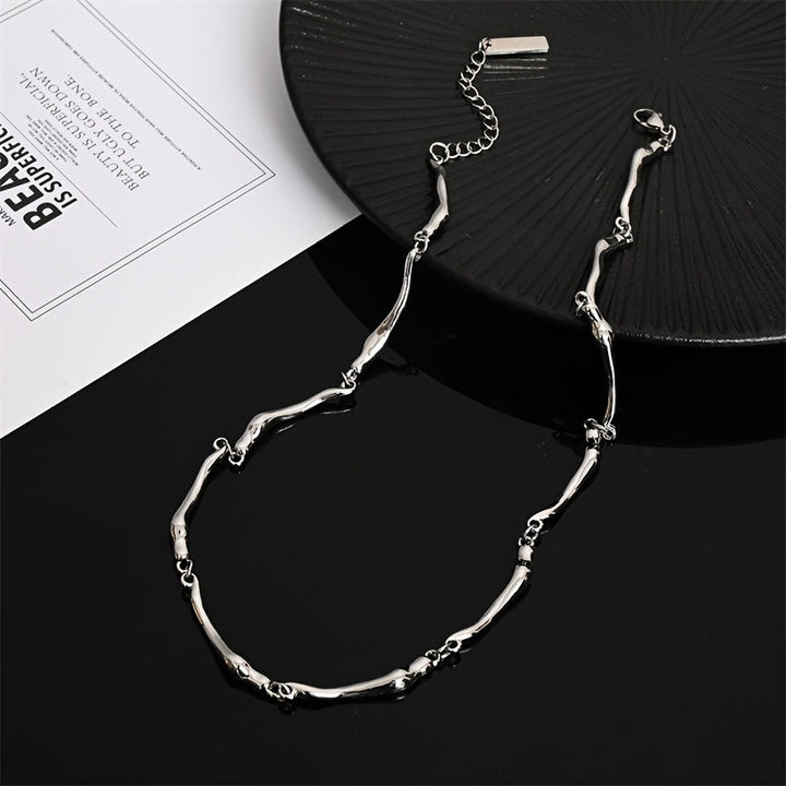 White gold necklace with an intertwined wave design