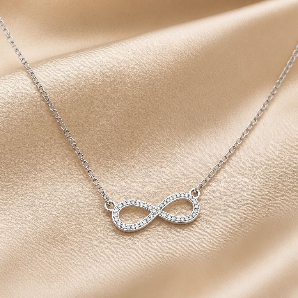 White gold necklace with an infinity pendant and zirconia cubic stones.